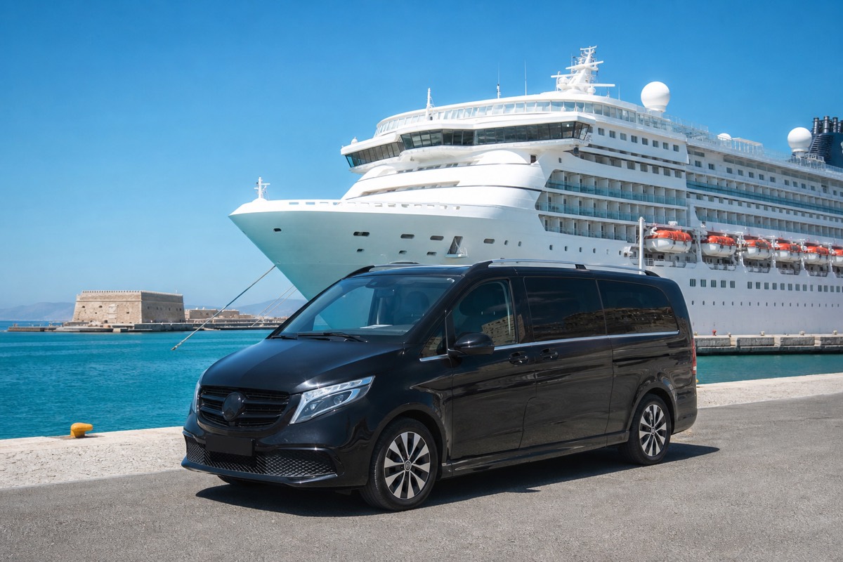 Private transfer minivan waiting at Heraklion port beside a cruise ship